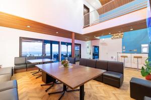 una sala da pranzo con tavolo e sedie in legno di 勝浦最南端の岬パワースポット天 a Katsuura