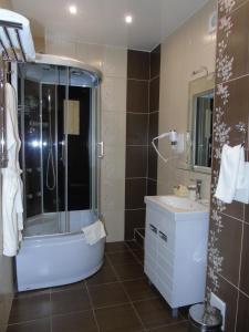 a bathroom with a shower and a sink at Domashny Ochag in Ukhta