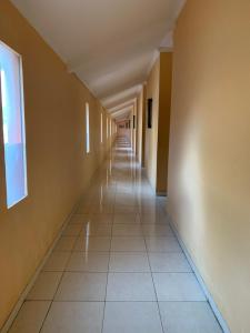 an empty hallway with a long long corridor at Fat Yogi Cottages in Kuta