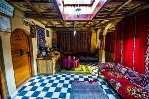 a living room with a couch and a table at Dar tiwira in Aït Baha