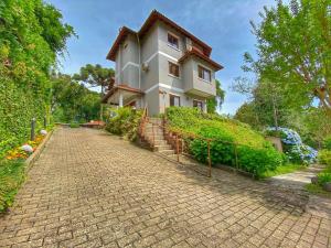 a house on a hill with a brick road at Pousada Flor De Canela in Canela