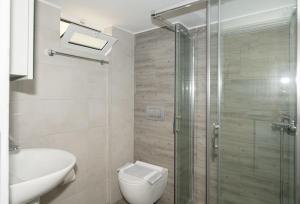 a bathroom with a shower and a toilet and a sink at Aretousa in Sougia