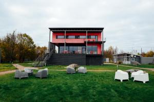 a building with tables and chairs in the grass at Lavola in Vyborg