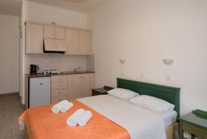 a bedroom with a bed with two towels on it at Aretousa in Sougia