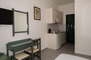 a small kitchen with a table and a counter at Aretousa in Sougia