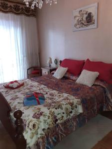 una camera da letto con un grande letto con cuscini rossi di ALLOGGIO ARCOBALENO a Brossasco