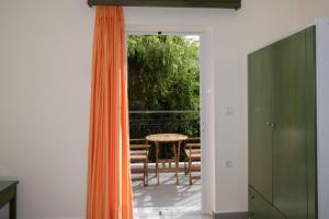 an open door to a patio with a table and chairs at Aretousa in Sougia
