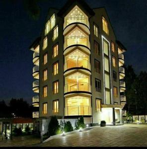 a large building with many windows at night at Apartman STUPOVI Zlatibor in Zlatibor