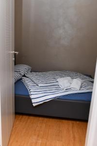a bed with two white towels on top of it at Apartman STUPOVI Zlatibor in Zlatibor +18 photos