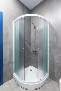 a shower with a glass door in a bathroom at Отель Баларам in Tula