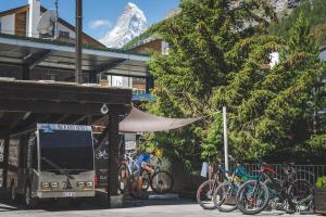 a group of bikes parked in front of a bus at SCHLOSS Cottage - A Swiss Experience in Zermatt