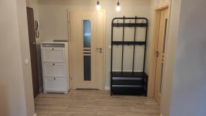 a hallway with a room with white cabinets and a bunk bed at Apart Hotel 38 (95m2) in Polanica-Zdrój