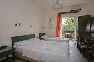 a bedroom with a bed with towels on it at Aretousa in Sougia