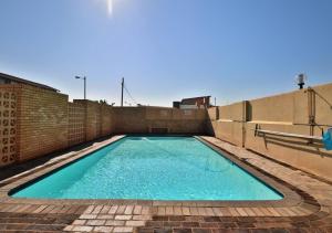 a swimming pool on top of a brick building at Sea Views at High Tide 1803 in Amanzimtoti