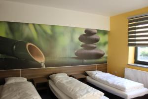 a room with two beds and a painting on the wall at Jordaszka in Wodzisław Śląski +64 photos