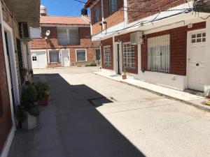 an empty alley between two brick buildings at Huilliches NQN in Neuquén