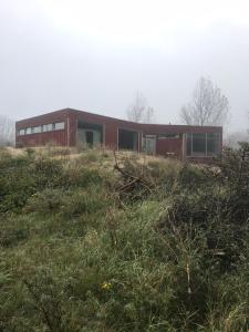 a building on top of a hill in a field at rodune in Koksijde