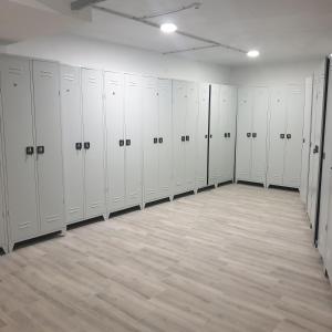 a large room with white lockers in a gym at Apartman Noalux Kopaonik in Kopaonik