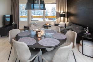 - une salle à manger avec une table et des chaises dans l'établissement Levin Kunkku B2 Apartment Grey, à Levi