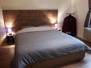 a bedroom with a large bed with two lamps at Appartement 80m2 dans belle demeure in Vrigne-aux-Bois