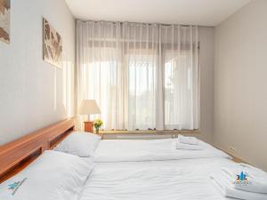 Łóżko lub łóżka w pokoju w obiekcie 3L Apartments Olympic Park