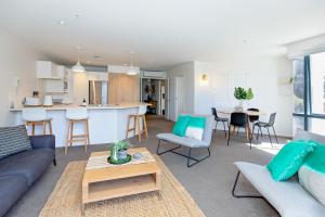 a living room with a couch and a table at Ocean Retreat 228 in Mount Maunganui