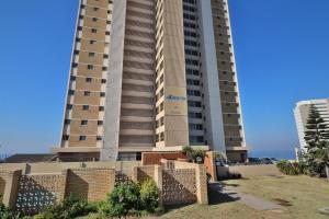 a tall building with a fence in front of it at Breathtaking Sea Views at High Tide 1803 in Amanzimtoti