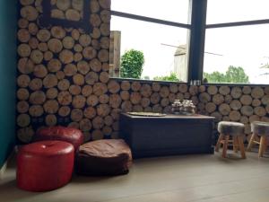 a room with a tub and a table and a window at Vakantiehuis Louiselotte in Alveringem +35 photos