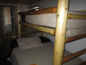 A bed or beds in a room at Log Inn & Pub