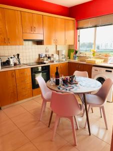 a kitchen with a table and chairs in it at Pool Apartment in Larnaca
