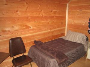 A bed or beds in a room at Log Inn & Pub