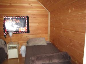 A bed or beds in a room at Log Inn & Pub