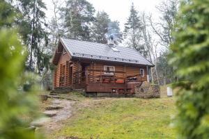 a log cabin in the woods with at Valkla Puhkekeskuse saunamaja in Kuusalu