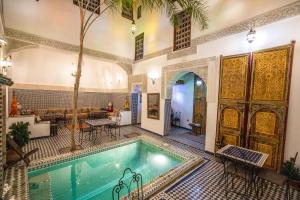 an indoor pool in a building with a house at Le Cèdre D'argent in Fez