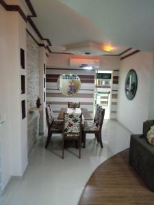 a dining room with a table and chairs at Apartamento em Guarapari in Guarapari