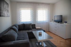 a living room with a couch and a tv at Apartman Ante in Livno