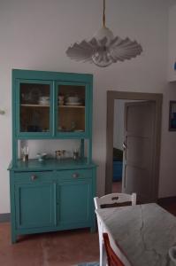 a blue cabinet in a room with a table at Masseria Montedoro in Ginosa Marina +27 photos