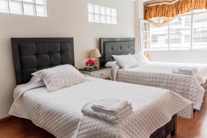 Ein Bett oder Betten in einem Zimmer der Unterkunft Residencial Velia & Victoria