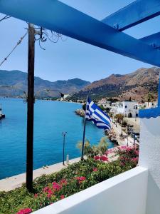 a view of the ocean from a balcony with a flag at Blue Sky Aparts in Livadia