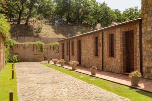 a brick building with potted plants on the side of it at Casena Mongerrati in Collesano