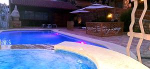 a swimming pool in a backyard at night at Casas Rurales Almoguer in Frailes