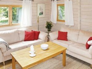 a living room with two couches and a coffee table at 4 person holiday home in TYRINGE in Tyringe