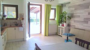 a kitchen with a sink and a table and a door at Morrovalle LOVE in Morrovalle +20 photos