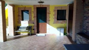 a front door of a house with a brick floor at Morrovalle LOVE in Morrovalle