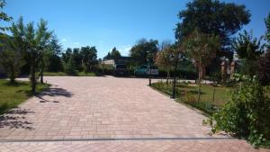 a brick walkway in a park with a van at Morrovalle LOVE in Morrovalle