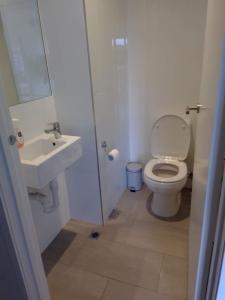 a bathroom with a toilet and a sink at Luxury Beach Front Appartment in Rosebud