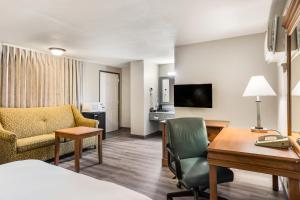 a hotel room with a bed and a desk and a room at Americas Best Value Inn - Lebanon in Lebanon