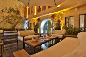 a patio with couches and a table in a building at Aja Cappadocia Cave Hotel in Urgup