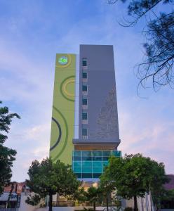 um edifício alto com um relógio em Zest Parang Raja Solo by Swiss-Belhotel International em Bonorejo