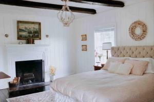 a bedroom with a large bed and a fireplace at Mayhurst Estate in Orange +73 photos